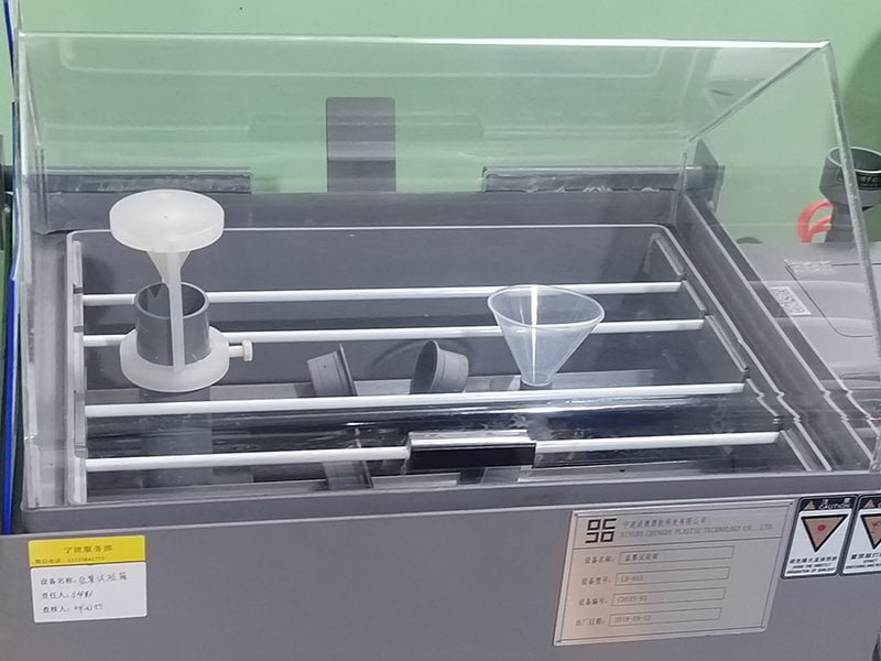 Salt spray testing chamber evaluating metal component corrosion resistance