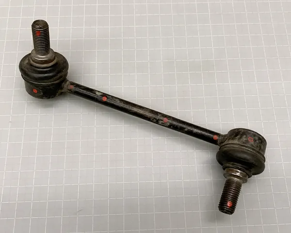 QC inspection of returned sway bar link showing measurement points