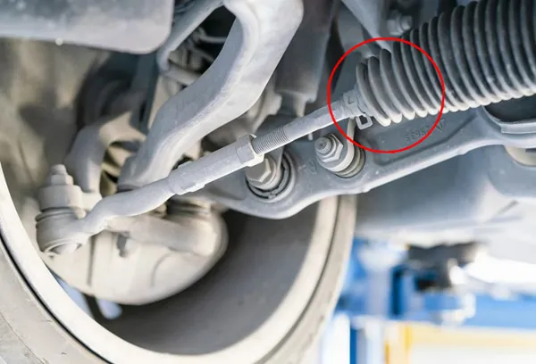 rack end inside steering bellows boot near steering rack